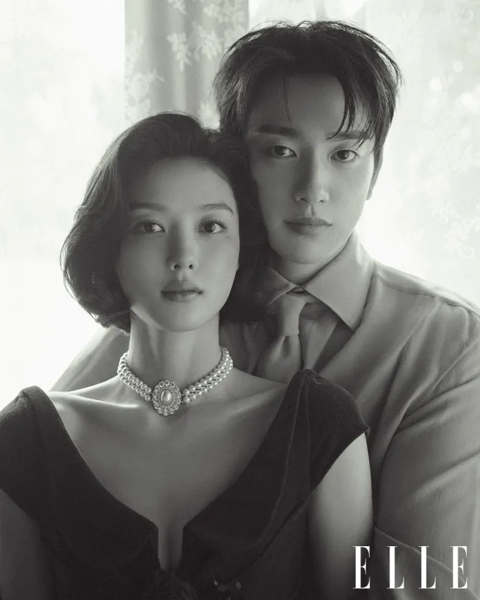 Kim You-jung and Jinyoung standing close together against a softly lit background.