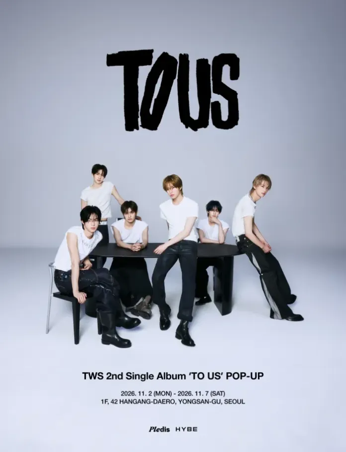 TWS in matching white t-shirts posing around a table against a plain backdrop, promoting the TWS 2nd Single Album 'TO US' and related pop-up event details.