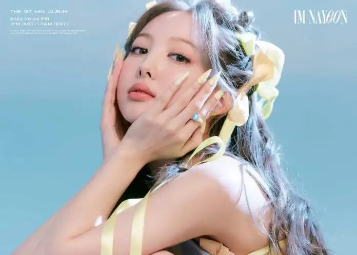 Nayeon resting her face on her hand in a concept photo for her 2022 debut mini album Im Nayeon
