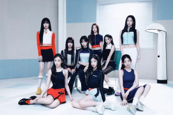 A2O LITE members posed together in a modern, brightly lit room with pastel-colored walls, dressed in stylish sportswear.