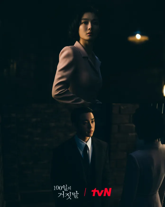 A dramatic scene featuring Kim Yoo-jung in a light pink suit and Park Jinyoung in a black suit, both looking at each other in a dimly lit, atmospheric setting.
