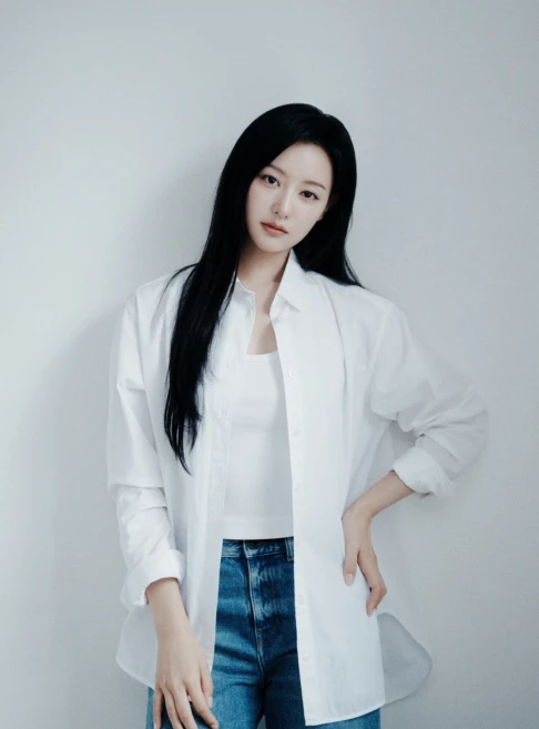 Kim Ji-won with long black hair wearing a white oversized shirt and a fitted white tank top, posing against a light gray background.