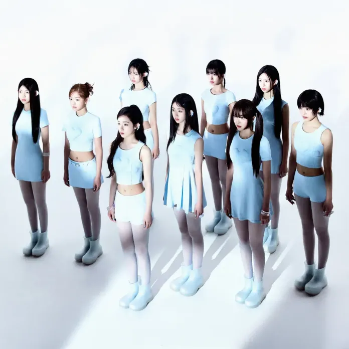 A2O LITE stands in two rows, all wearing matching light blue outfits and oversized boots, against a stark white background. The scene features a mix of various poses and styles, highlighting their contemporary fashion.