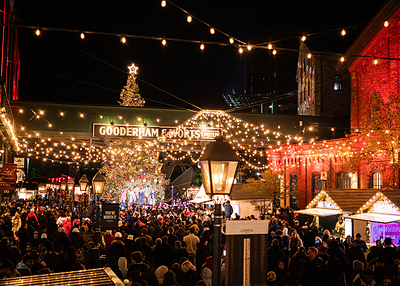 Visitors gather beneath the holiday lights and towering Christmas tree at The Distillery Winter Village in Toronto. Welcoming more than one million visitors each season, the annual holiday tradition opens November 12, 2026, with its Christmas tree lighting ceremony, kicking off seven weeks of live entertainment, holiday shopping, seasonal food and drinks, and special experiences through January 3, 2027. (Photo: The Distillery Winter Village, 2025)