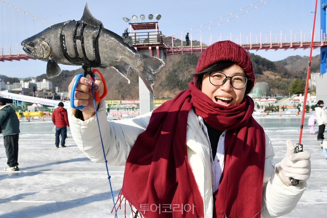 화천산천어축제에서 물고기 낚고 좋아하는 관광객 모습/사진-화천군