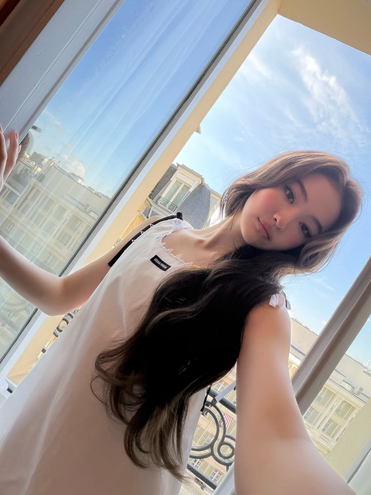 화이트 미니 드레스 | 리본 디테일과 로고 패치로 미우미우 소녀 감성을 담아낸 슬리브리스 드레스 /사진=미야오 엘라 인스타그램