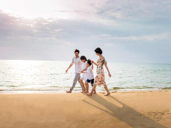 Family is walking on Bai Dai beach, Phu Quoc
