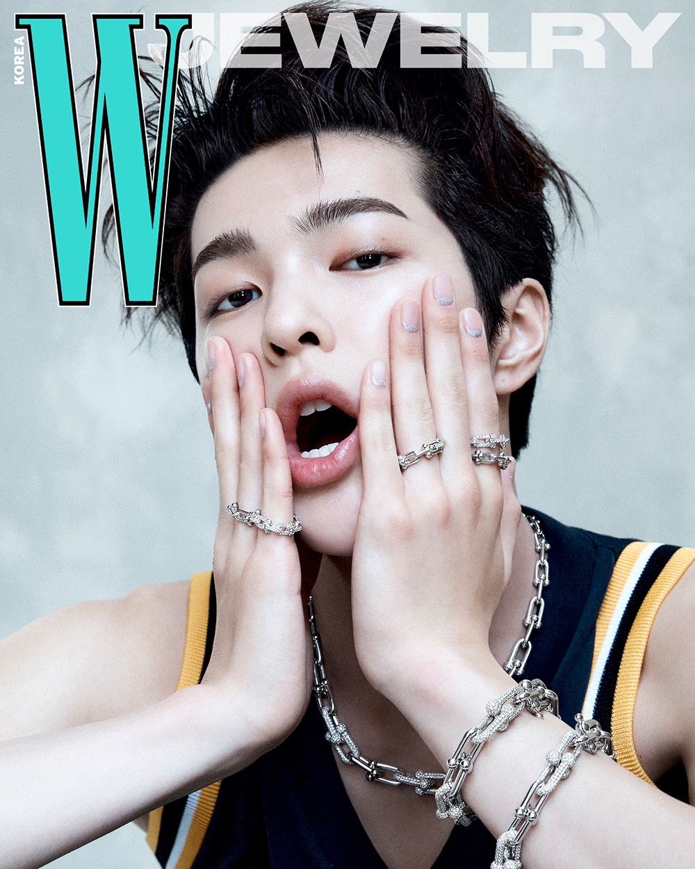 블랙·옐로우 스포츠 탱크탑을 입고 티파니앤코 하드웨어 실버 체인 목걸이와 링, 브레이슬릿을 착용해 두 손으로 얼굴을 감싸고 있다 / 사진=더블유 코리아