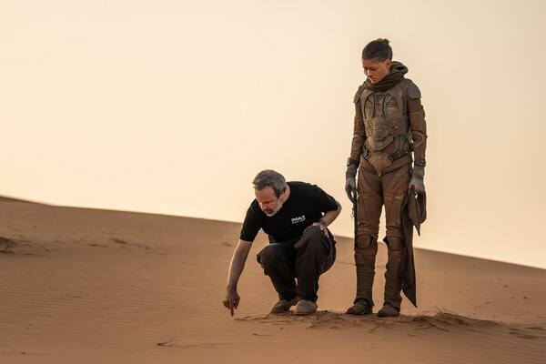 (L-r) Director/Writer/Producer DENIS VILLENEUVE and Zendaya on the set of Warner Bros. Pictures and Legendary Pictures’ action adventure “DUNE: PART THREE,” in the Liwa Desert, Abu Dhabi. A Warner Bros. Pictures release. Photo by Niko Tavernise.