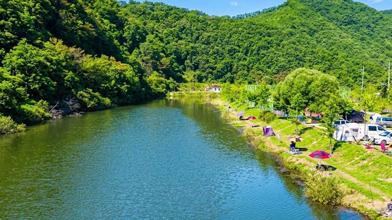 호숫가를 따라 아늑하게 들어선 오토캠핑장 전경. / 음성군 문화관광, ai