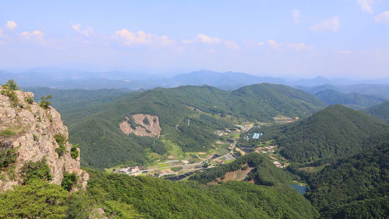 구름다리를 지나 고지대에서 한눈에 내려다보이는 진안의 구비치는 산줄기와 마을 전경. / 진안군