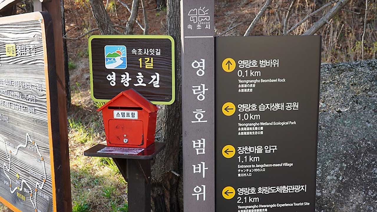 초사잇길 스탬프함과 함께 영랑호 범바위 및 주변 명소까지의 거리를 알려주는 이정표. / 속초시