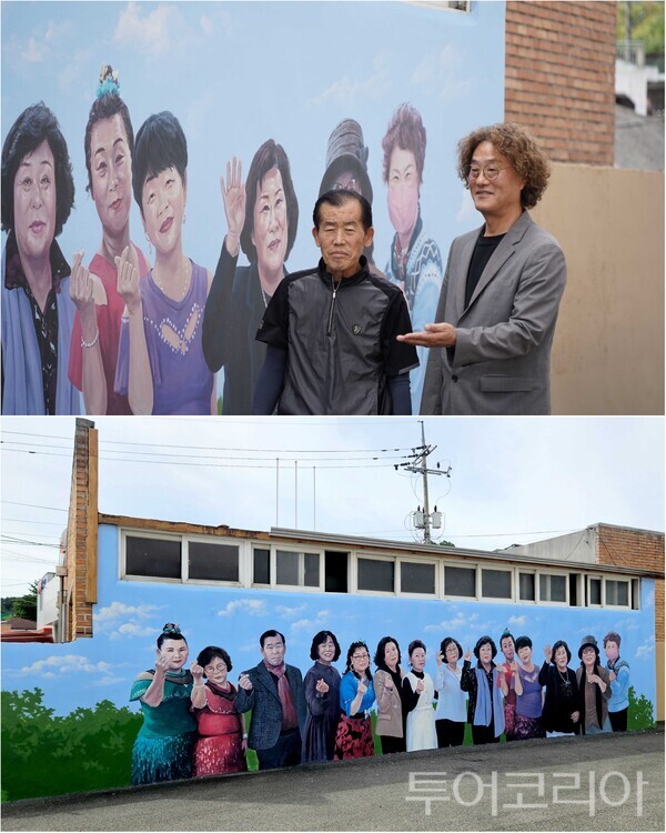 ▲김지광(上 오른쪽) 공주문화관광재단 대표이사가 이인벽화마을에 대해 관광객들에게 설명하고 있다. /사진 편집-류석만 기자