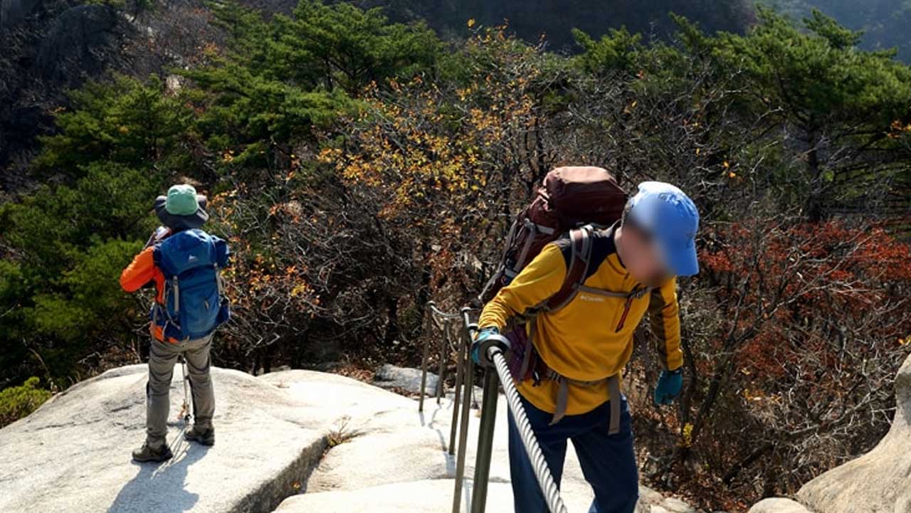 도봉산 등산객이 신선대 구간 철난간을 잡고 급경사 암벽을 오르고 있다. / 의정부시 문화관광