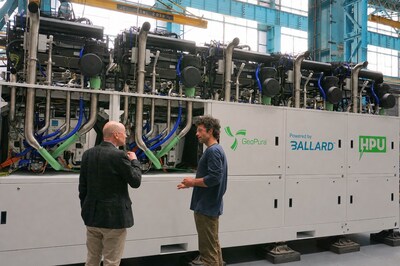 GeoPura CEO Andrew Cunningham (left) and CTO Theo Elmer (right) in front of an HPU-2 500kW system containing Ballard Fuel Cell Engines. 